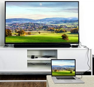 An LCD TV on a TV cabinet and a laptop connected with a DP cable, with both showing same content in Mirror Mode  